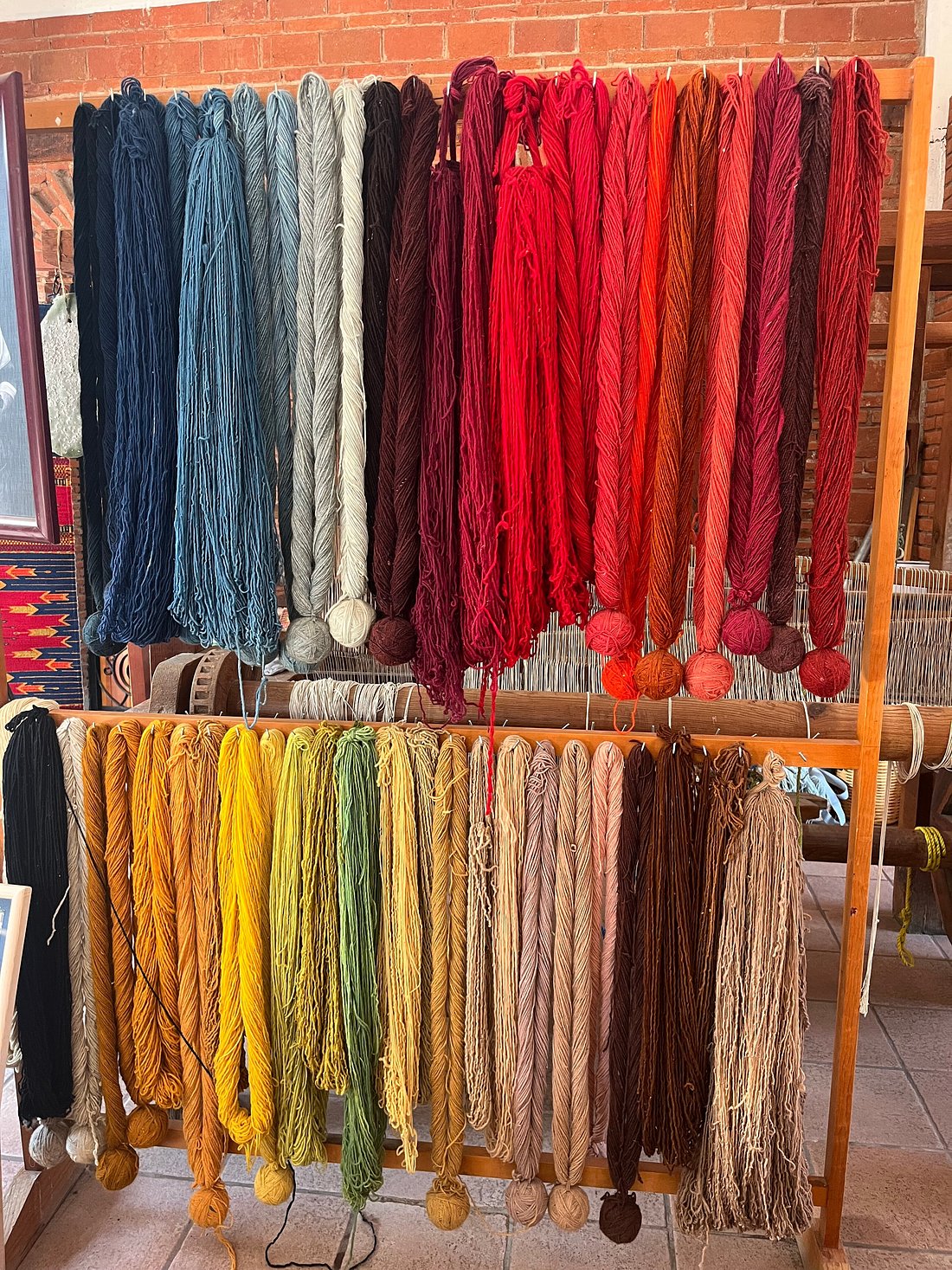 Skeins drying in the workshop after baths of cochineal, indigo, marigold, walnut and pomegranate.