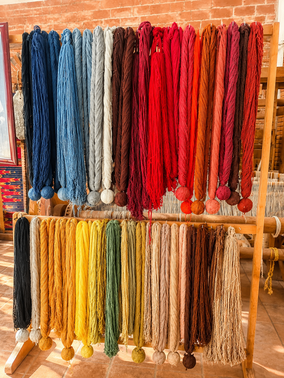 Skeins drying in the workshop after baths of cochineal, indigo, marigold, walnut and pomegranate.